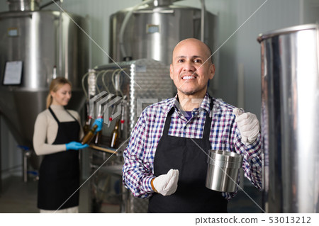 Man working on modern brewery. Man working on modern brewery. 53013212