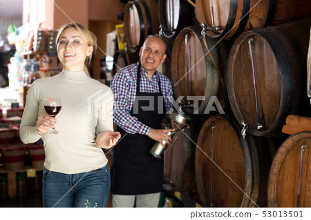 Woman having glass of wine in wine house Woman having glass of wine in wine house 53013501