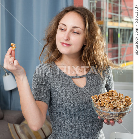 Woman holding bowl of walnuts 53013537