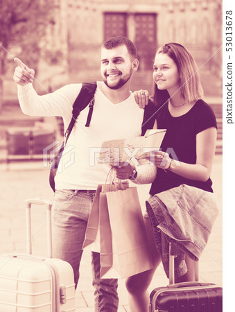 Young tourists with baggage traveling with map Young tourists with baggage traveling with map 53013678