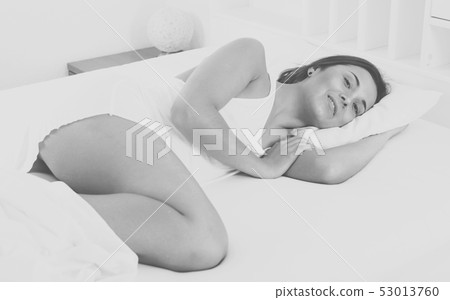 Woman sleeping in bed 53013760