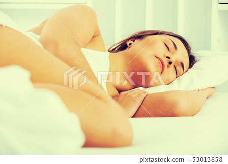 Woman sleeping in bed Woman sleeping in bed 53013858