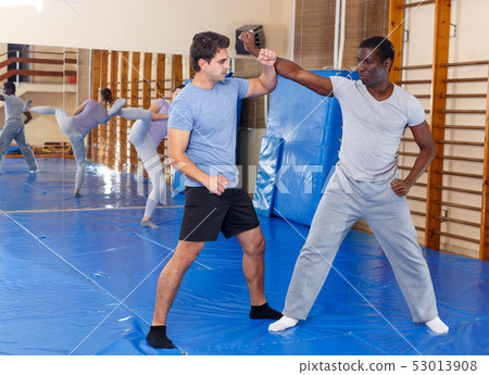 Two men practicing self defense techniques Two men practicing self defense techniques 53013908