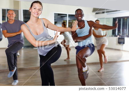 Cheerful people practicing vigorous lindy hop movements in dance class 53014077