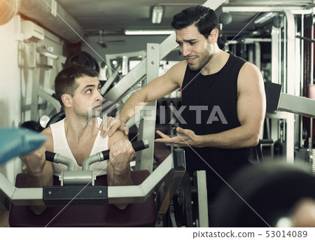 Man during training with instructor in gym 53014089