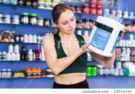 Sports woman reading label before buying 53014195