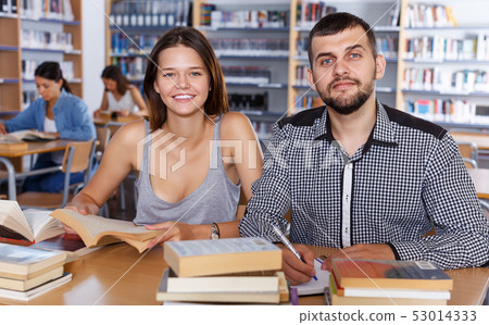 female and male students working in university library female and male students working in university library 53014333