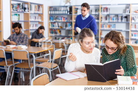 Two female students studying in library 53014438