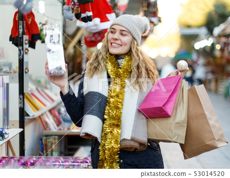 Young woman buying Christmas decorations Young woman buying Christmas decorations 53014520