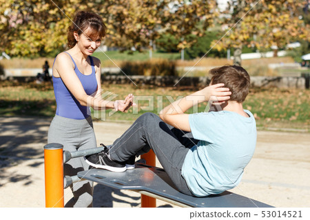 Boy doing push-ups on sport bench Boy doing push-ups on sport bench 53014521