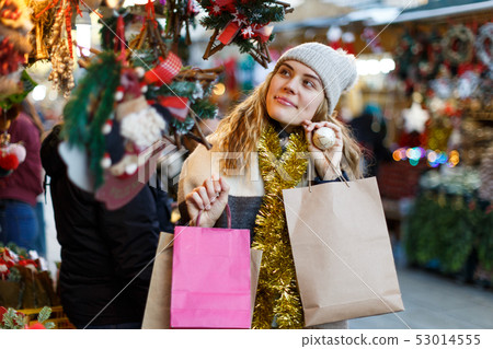 Girl holding paper bags at Christmas fair 53014555