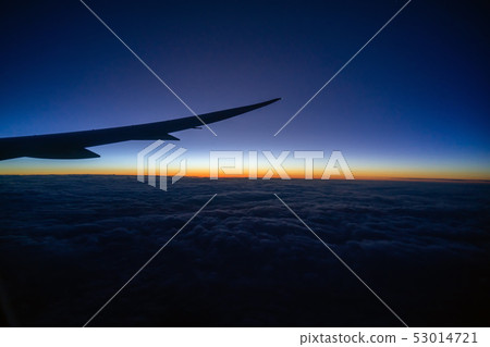 Scene of Airplane wing over the cloud and fantastic sky at sunrise time when flying above the land, Nature and travel concept 53014721