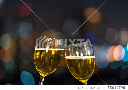 Clinking with two beer mug or glasses over the photo blurred of cityscape for celebrate, party and celebrate with happy new year concept Clinking with two beer mug or glasses over the photo blurred of cityscape for celebrate, party and celebrate with happy new year concept 53014796