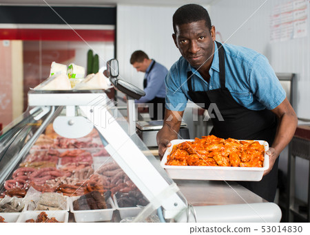 Butcher preparing meat products 53014830