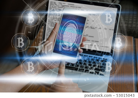Hand pressing the Fingerprint scan the smart phone with technolog icon for unlock the screen over the bicoins icon and digital screen, business and technology concept,Fintech and AI concept Hand pressing the Fingerprint scan the smart phone with technolog icon for unlock the screen over the bicoins icon and digital screen, business and technology concept,Fintech and AI concept 53015043
