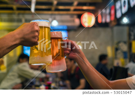 Two Glasses of Beer cheers together between friend in the bar and restaurant. relax and drink concept Two Glasses of Beer cheers together between friend in the bar and restaurant. relax and drink concept 53015047