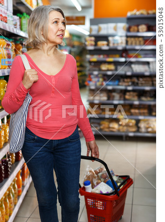 Mature woman shopping in grocery Mature woman shopping in grocery 53015048