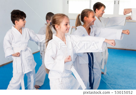 Children are practicing new technique by repeating for the trainer Children are practicing new technique by repeating for the trainer 53015052