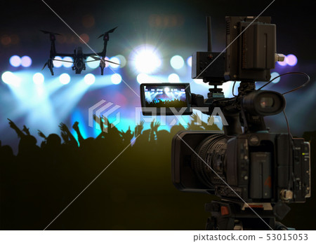 closeup Video Cameraman taking Concert crowd in silhouettes of Music fanclub with show hand action which follow up the songer at the front of stage with follow light, musical and concert concept closeup Video Cameraman taking Concert crowd in silhouettes of Music fanclub with show hand action which follow up the songer at the front of stage with follow light, musical and concert concept 53015053