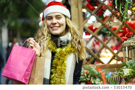 Girl holding paper bags at Christmas fair 53015470