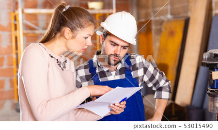Professional builder is talking to client at home Professional builder is talking to client at home 53015490