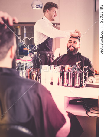 Hairdresser doing new haircut Hairdresser doing new haircut 53015492