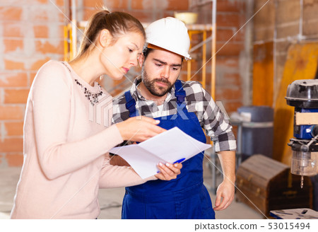Professional builder is talking to client at home Professional builder is talking to client at home 53015494