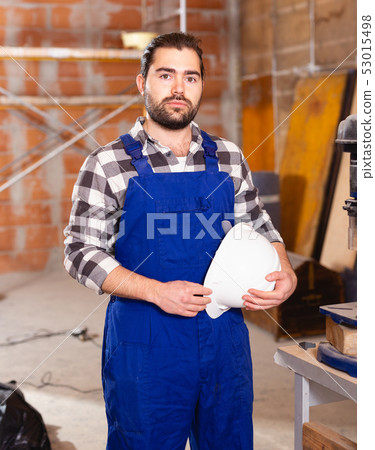 Portrait of worker who works on drilling machine Portrait of worker who works on drilling machine 53015498