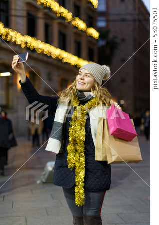 Smiling young woman taking selfie Smiling young woman taking selfie 53015501