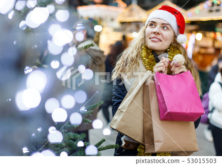 Girl holding paper bags at Christmas fair 53015503