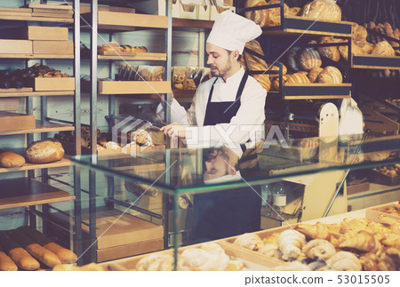 Young man is offering fresh tasty croissant Young man is offering fresh tasty croissant 53015505