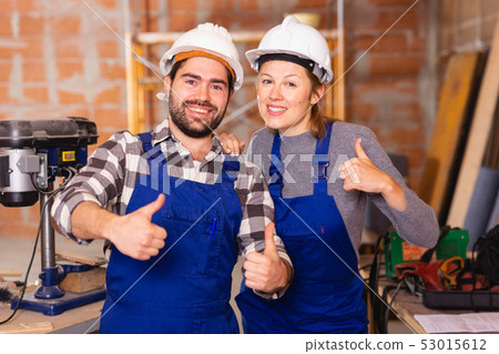 Two professional builders with thumbs up Two professional builders with thumbs up 53015612