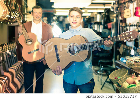 Salesman with a young assistant in the musical store Salesman with a young assistant in the musical store 53015717