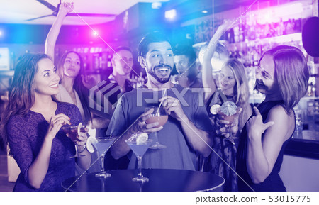 Man with two female are drinking cocktails Man with two female are drinking cocktails 53015775