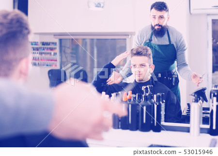 man client expressing dissatisfaction about his haircut at hair salon man client expressing dissatisfaction about his haircut at hair salon 53015946
