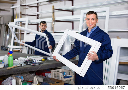 Workmen inspecting PVC manufacturing output in workshop Workmen inspecting PVC manufacturing output in workshop 53016067