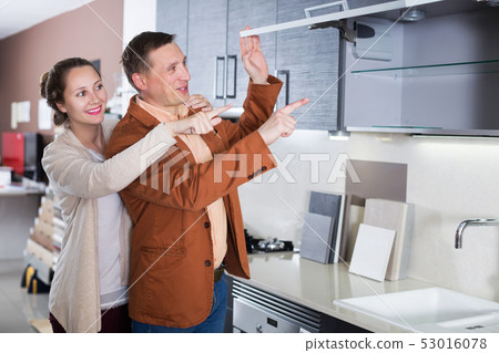 Couple looking at modern kitchen Couple looking at modern kitchen 53016078