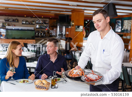 Waiter demonstrating tray of lobsters Waiter demonstrating tray of lobsters 53016139