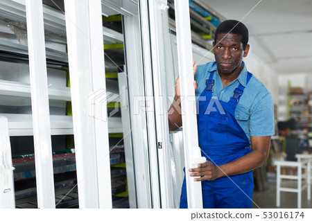 Adult man master is looking on modern window frame Adult man master is looking on modern window frame 53016174