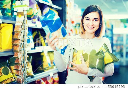 woman choosing delicious snacks in supermarket woman choosing delicious snacks in supermarket 53016293
