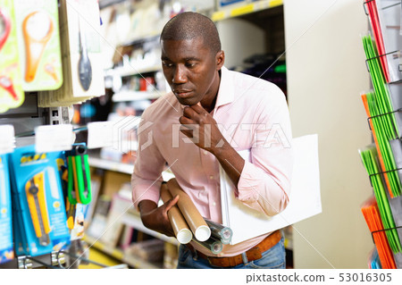 Portrait of friendly African man choosing stationery at shop Portrait of friendly African man choosing stationery at shop 53016305