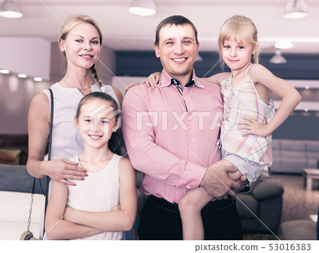 Family of four are pleased by new sofa Family of four are pleased by new sofa 53016383