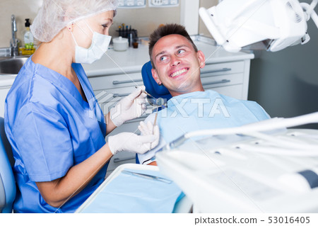 Male patient getting dentist treatment Male patient getting dentist treatment 53016405