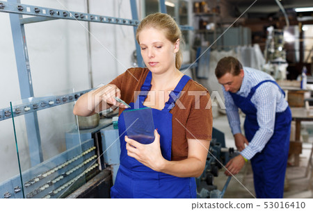 Woman measuring glass with trammel 53016410