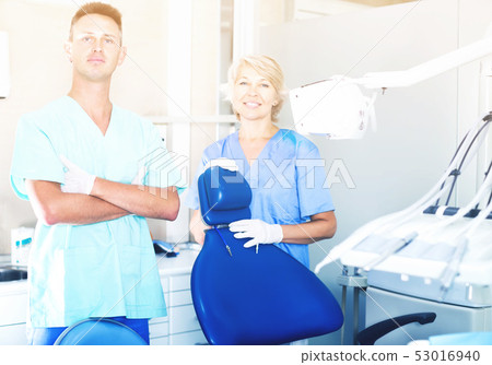 Two professional confident dentists near dental chair Two professional confident dentists near dental chair 53016940