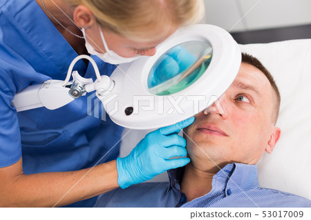 Woman doctor is examining patient before the procedure 53017009