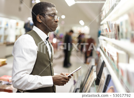 Man looking at souvenir products Man looking at souvenir products 53017792