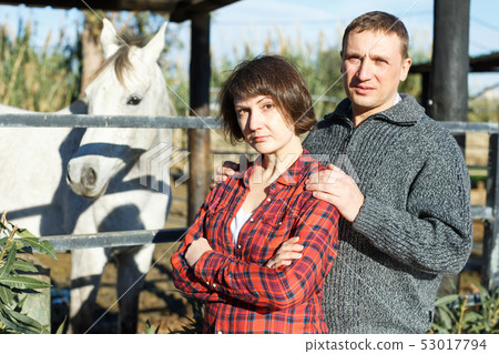 Man and woman at horse stable Man and woman at horse stable 53017794