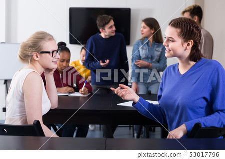 Smiling students having conversation at recess Smiling students having conversation at recess 53017796