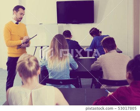 Teacher inspecting working process 53017805